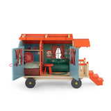 Les Minouchkas toy caravan opened to show a furnished interior with dollhouse bed, couch, and table.