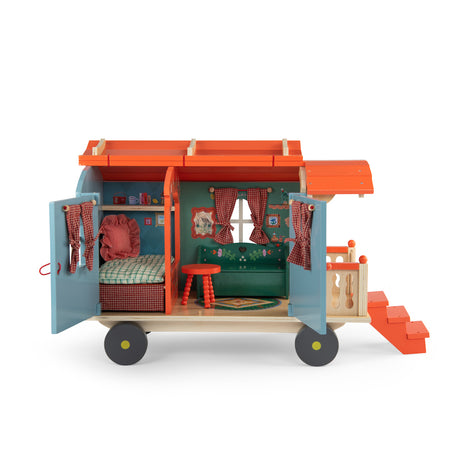 Les Minouchkas toy caravan opened to show a furnished interior with dollhouse bed, couch, and table.