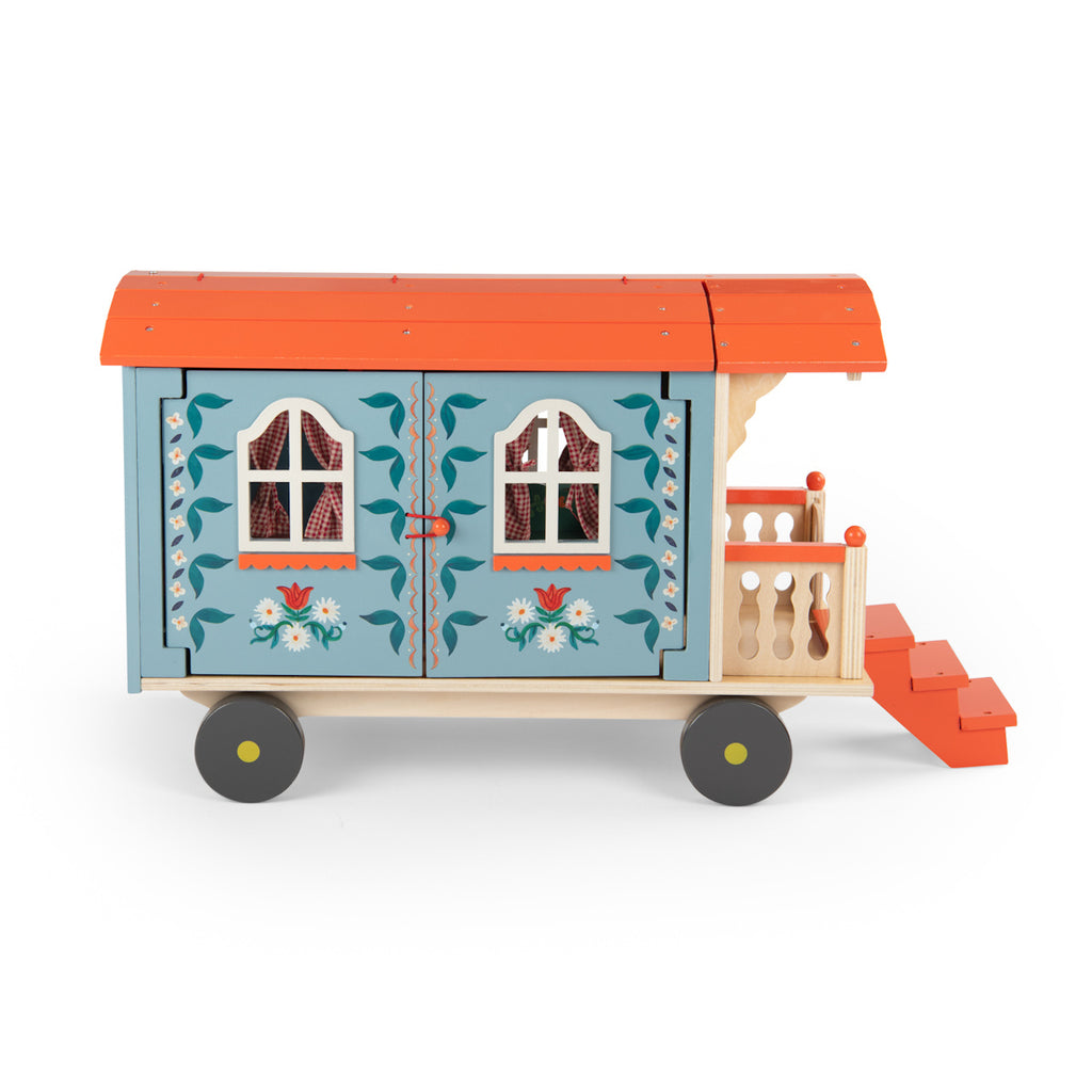 Toy wagon with a colorful design, featuring a blue body with floral patterns, an orange roof, and tiny stairs leading to a small porch on wheels.