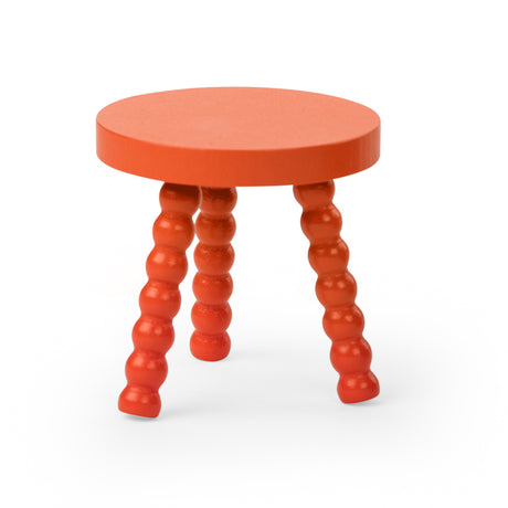 Orange wooden stool with a round top and three bobbin turned legs.
