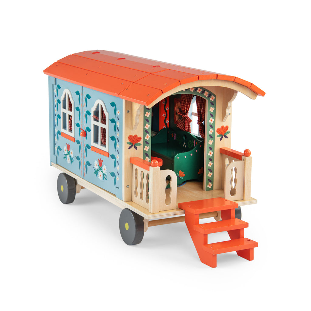 Toy wagon with a colorful design, featuring a blue body with floral patterns, an orange roof, and tiny stairs leading to a small porch on wheels.