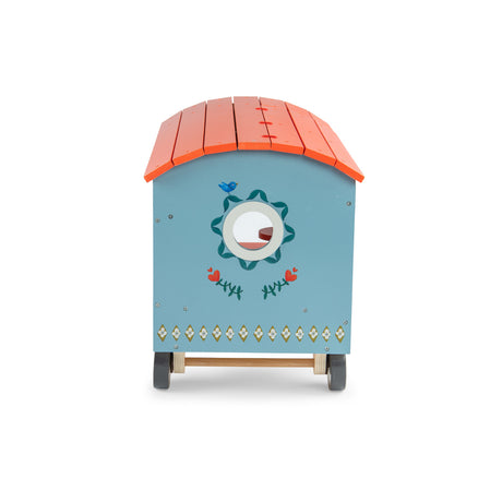 Les Minouchkas wooden toy caravan with orange roof and blue painted floral details.
