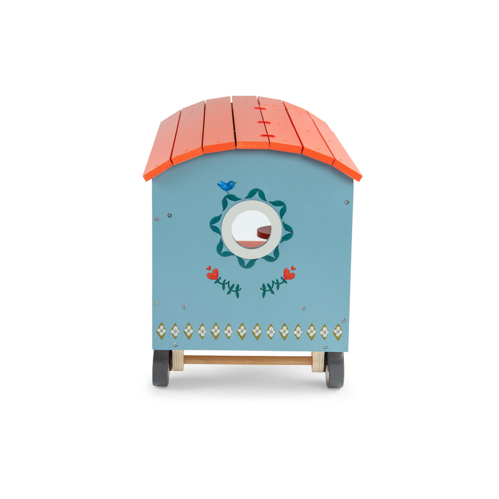 Toy wagon with a colorful design, featuring a blue body with floral patterns, an orange roof, and tiny stairs leading to a small porch on wheels.