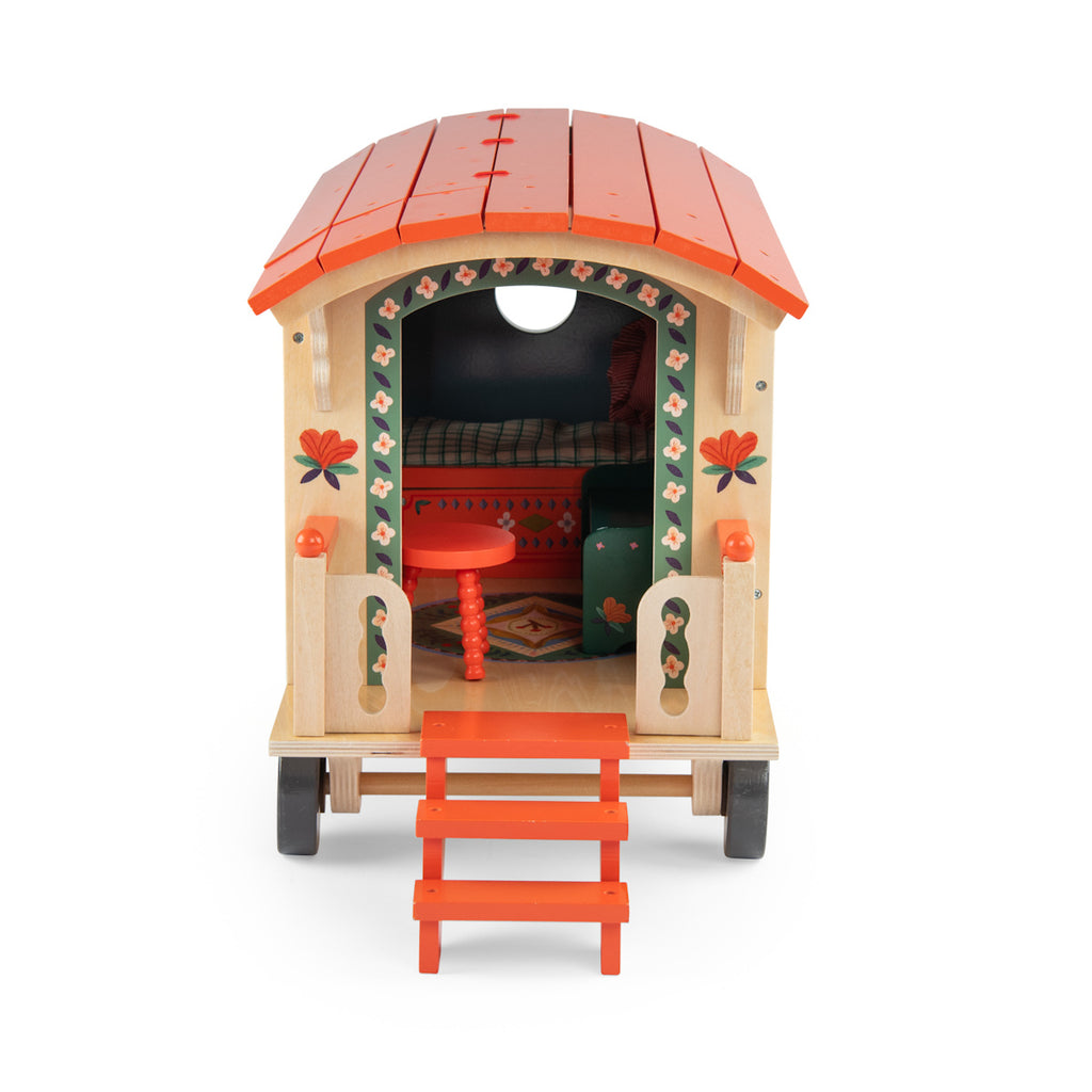 Toy wagon with a colorful design, featuring a blue body with floral patterns, an orange roof, and tiny stairs leading to a small porch on wheels.