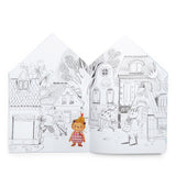 Les Minouchkas coloring book open page showing a cute illustrated village street with animal characters.