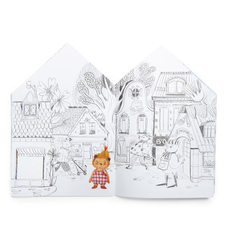 Les Minouchkas coloring book open page showing a cute illustrated village street with animal characters.