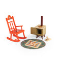 Les Minouchkas cozy living room toy set with orange rocking chair, miniature stove, and rug.