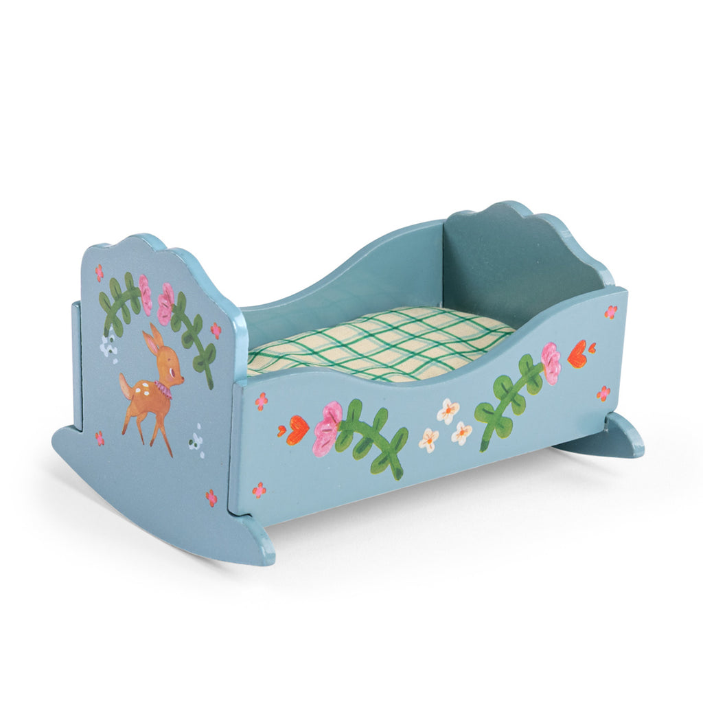 Blue wooden toy bed with floral and deer designs, featuring a grid-patterned mattress. The bed has a playful, whimsical charm.