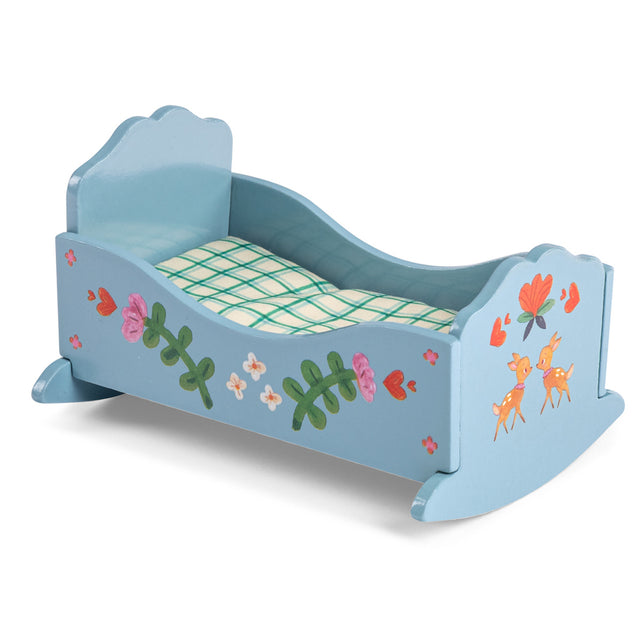 Blue wooden toy cradle with painted flowers and deer for Les Minouchkas dolls, featuring plaid bedding.