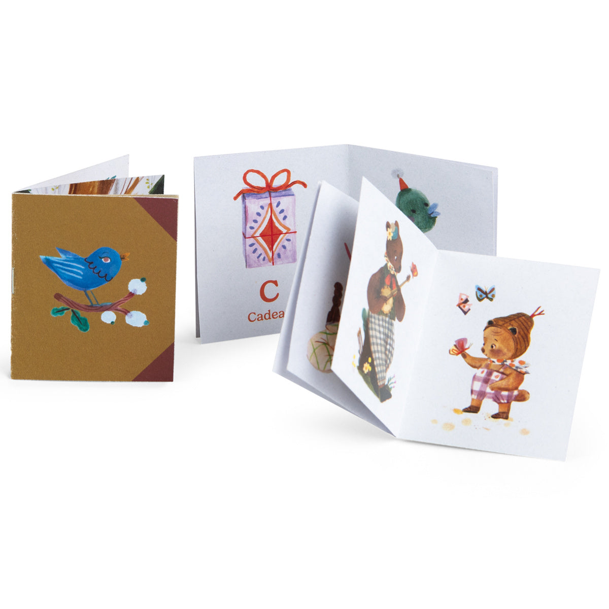 Les Minouchkas fireside accessories miniature storybooks with cute animal illustrations.