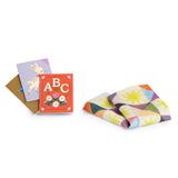 Les Minouchkas miniature ABC books and a colorful patterned doll blanket toy accessory set.
