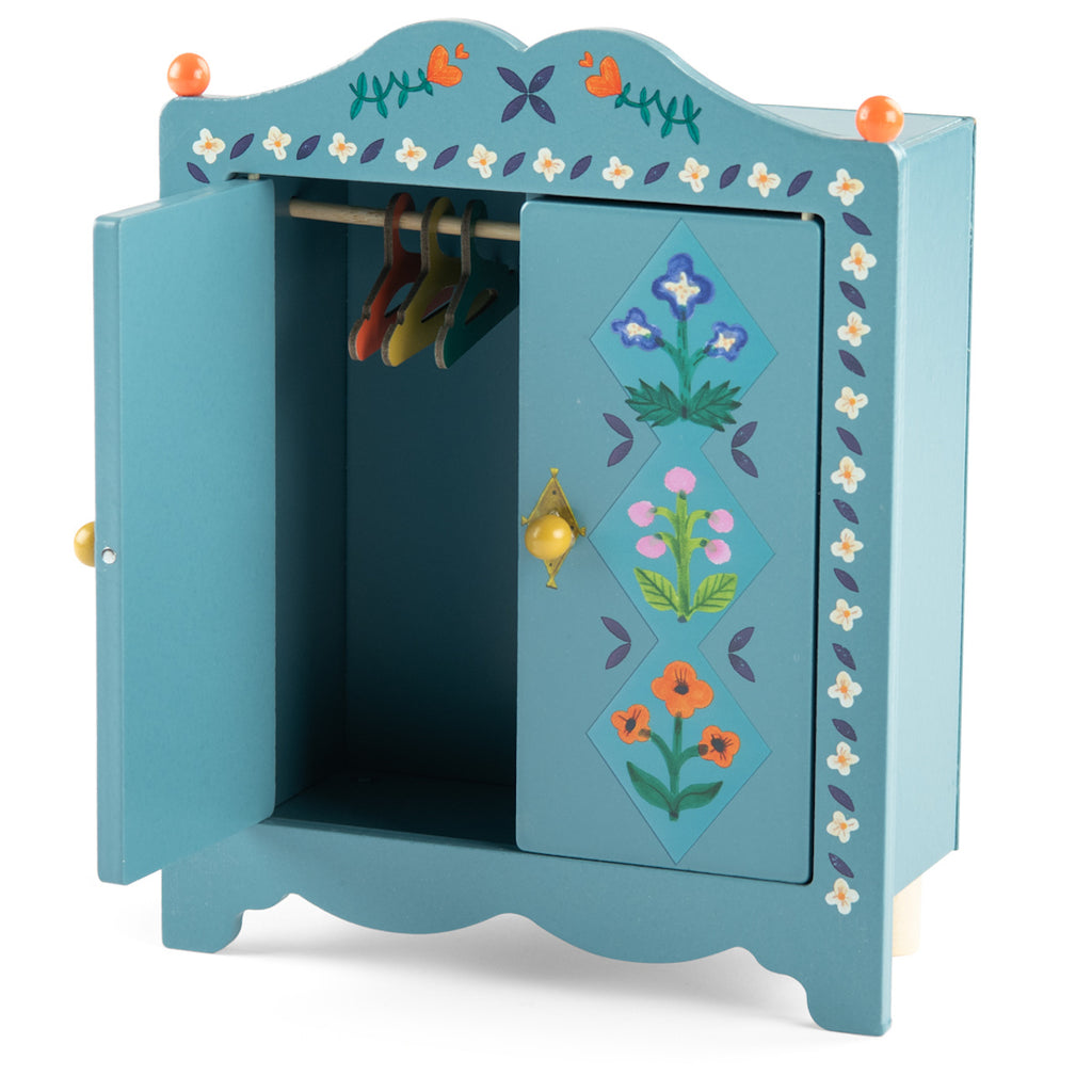 Blue wooden toy wardrobe with floral patterns and orange knobs. One door is open, revealing multicolored hangers inside. Cheerful and decorative.