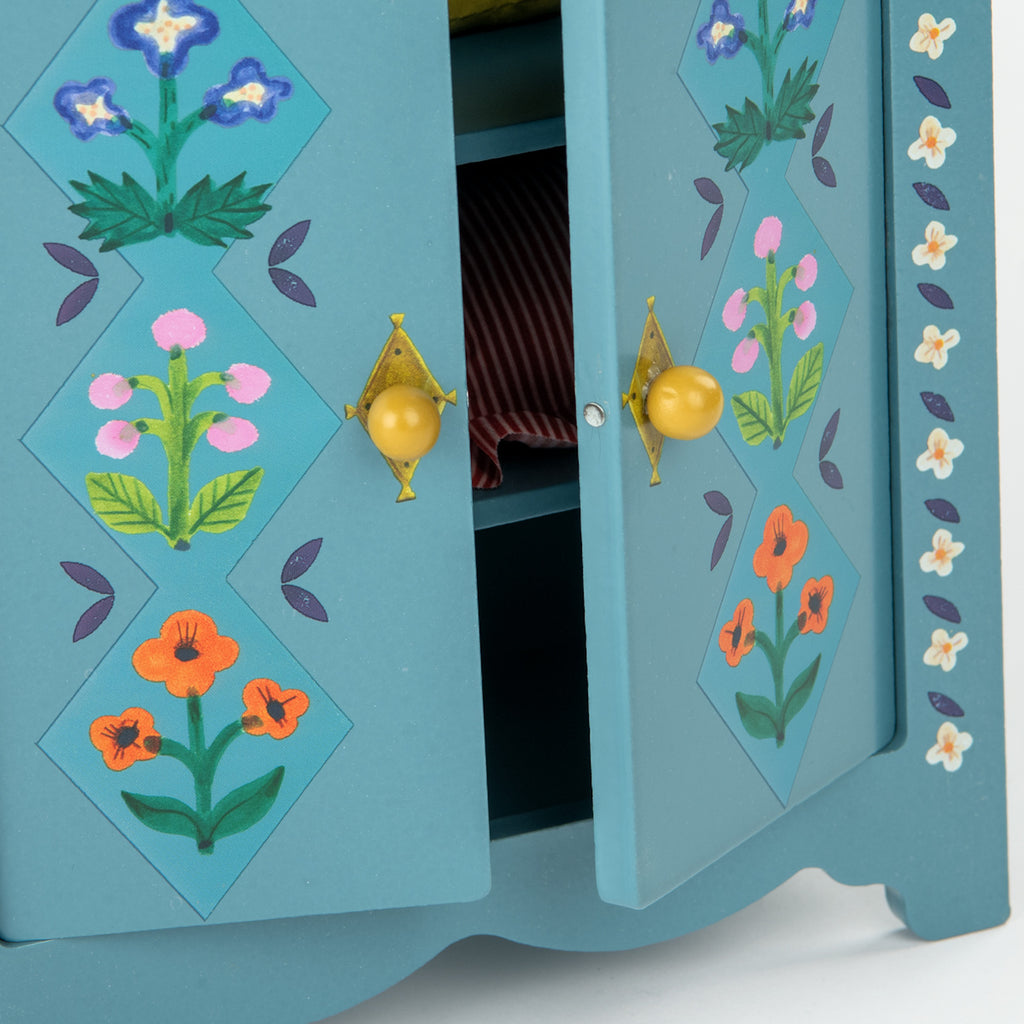 Blue wooden toy wardrobe with floral patterns and orange knobs.