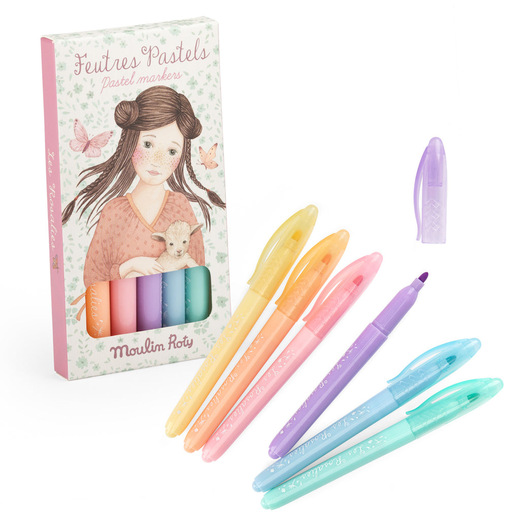 A set of six pastel markers in yellow, pink, orange, purple, blue, and mint is displayed. The packaging features an illustration of a girl with a lamb.