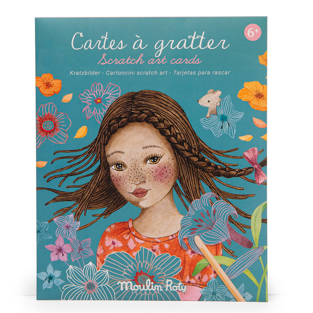 Illustrated cover of a scratch art card set featuring a girl with braids and freckles surrounded by colorful flowers, a mouse, and the text in multiple languages.