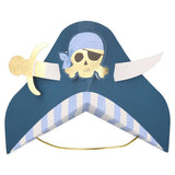 A blue paper pirate party hat with a skull graphic, a gold sword accent, and an elastic strap.