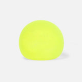 Smooth, round neon lime green stress toy sitting on a plain white background.