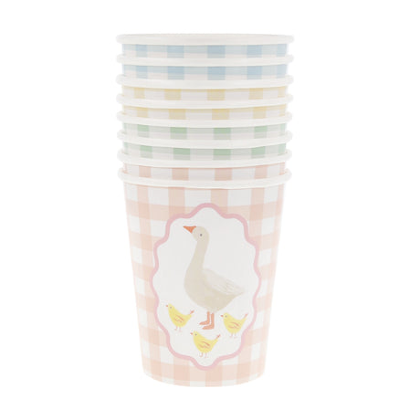 A stack of pastel gingham paper cups, with the front pink cup featuring an illustration of a goose and chicks.