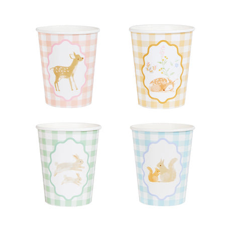 Four pastel gingham paper cups featuring illustrations of a deer, sleeping fawn, rabbits, and squirrels.