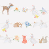 Watercolor woodland animal garland featuring deer, geese, rabbits, a fox, and squirrels on strings.