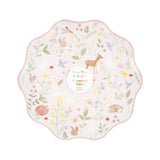 Scalloped paper plate with a pastel woodland animal and floral pattern.