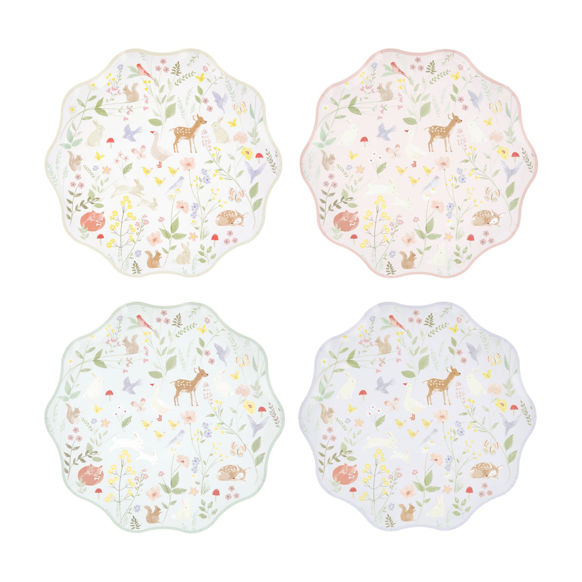 Four wavy-edged paper plates in pastel colors featuring a woodland animal and wildflower pattern.