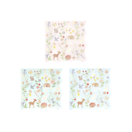 Three paper napkins in pink, mint, and blue with a matching pastel woodland animal and floral pattern.