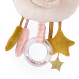 Close-up of a plush baby toy featuring a clear rattle ring, soft stars, and fabric ribbons in pink and mustard gold.