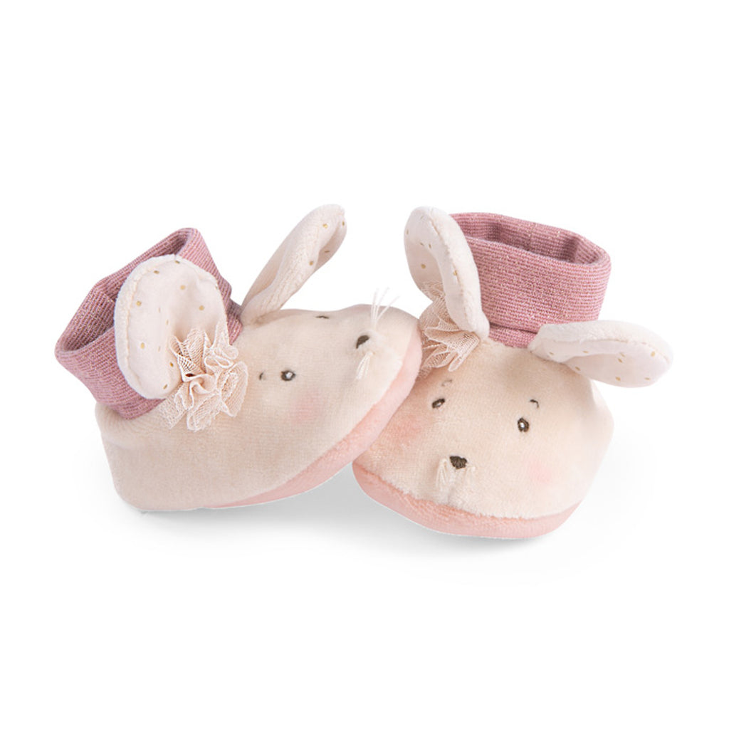 Soft baby booties shaped like mouse, featuring floppy ears and pink cuffs, arranged playfully against a white background, conveying warmth and cuteness.