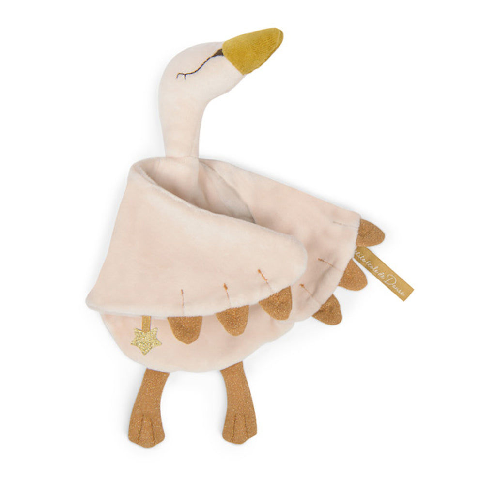 Soft, plush toy in the shape of a light pink and brown swan with wide wings. It features stitched eyes, a golden beak, and a tiny star accent.