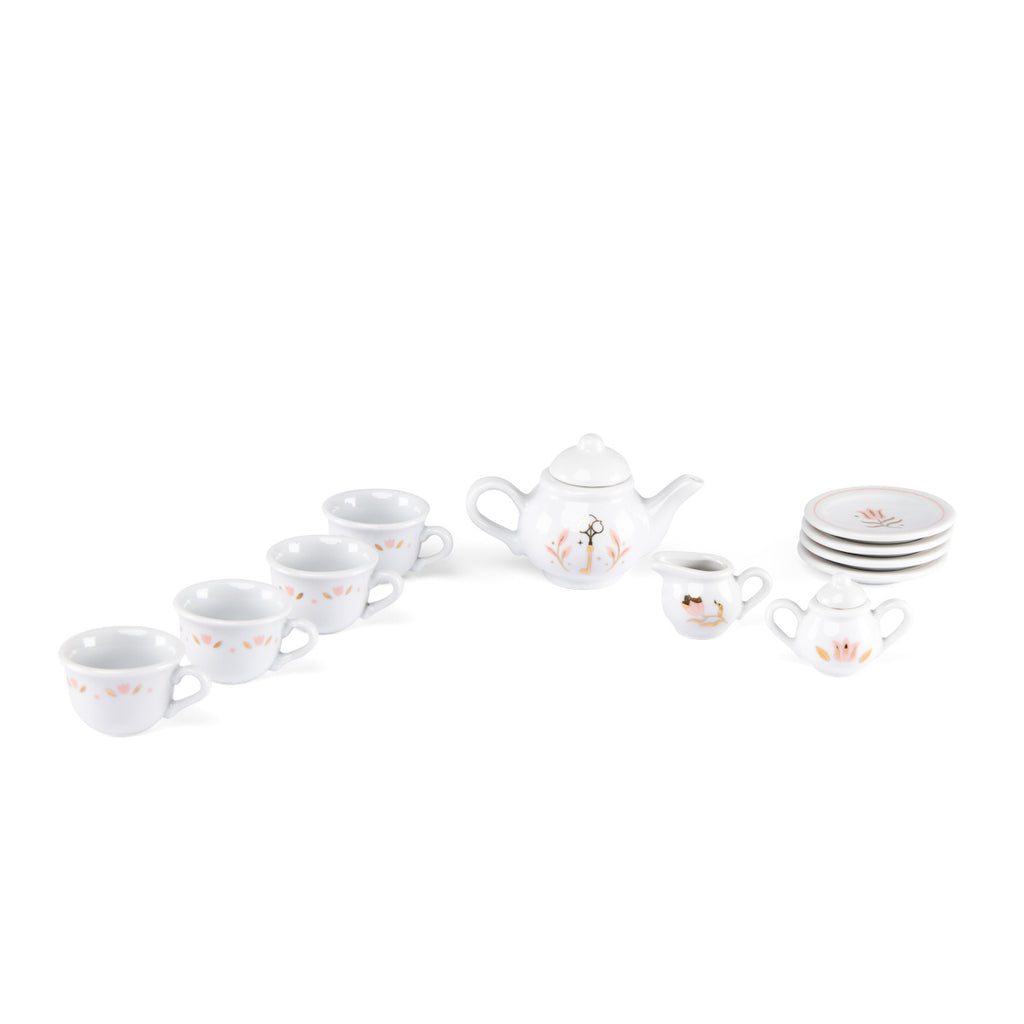White ceramic tea set with pastel flower designs; includes a teapot, six cups, a creamer, a sugar bowl, and four stacked saucers, arranged neatly.