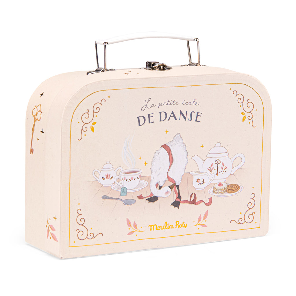 Beige suitcase labeled "La petite école DE DANSE" with a whimsical illustration of a tea set and a bow-wearing sheep, evoking a playful, elegant tone.