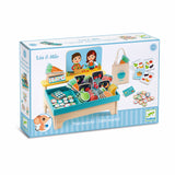 Djeco Lea & Milo Little Market wooden play set with toy food, scale, and coins for kids role play.