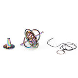 Rainbow metal gyroscope spinning top kit with stand and starter string on white background.