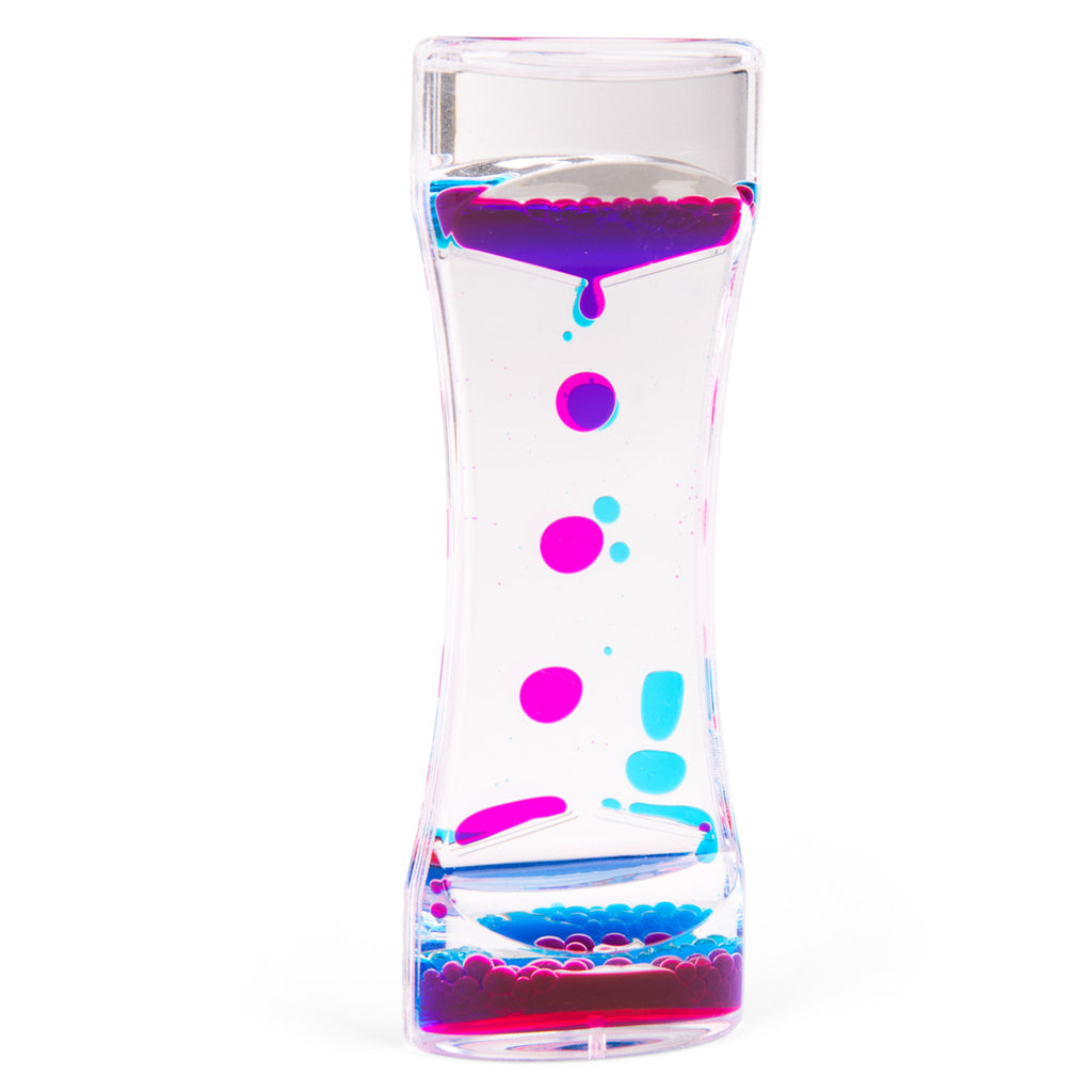 A clear hourglass-shaped liquid timer with vibrant pink and blue droplets cascading down, creating a calming visual effect against a white background.