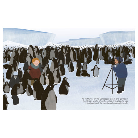 A child and a photographer stand on icy terrain, surrounded by a large colony of penguins. Icebergs are visible in the background. The mood is curious and adventurous.