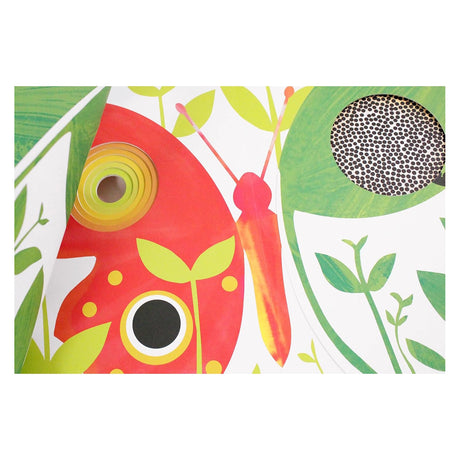Close-up of a colorful children's book with cut-outs, featuring a vibrant red butterfly and green garden illustrations.