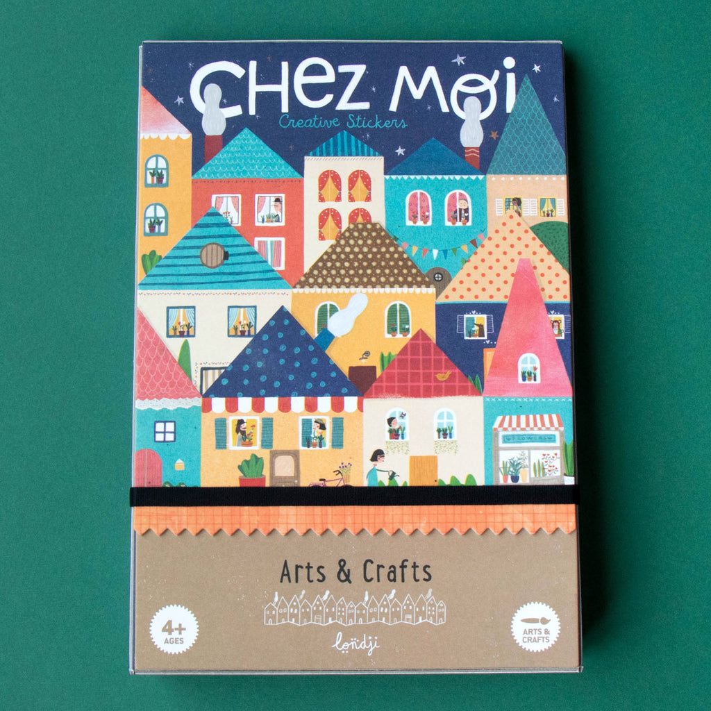 Colorful box of "Chez Moi Creative Stickers" on green background. Features vibrant, whimsical houses with patterns. Text reads "Arts & Crafts, 4+ Ages, Londji."
