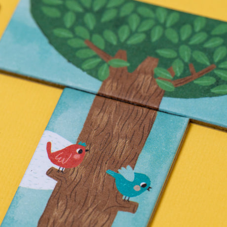 Londji Piu Piu board game tiles featuring a red and blue bird on a brown tree trunk against a yellow background.