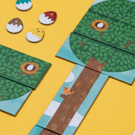 Londji Piu Piu game pieces showing illustrated bird nests in trees and small bird tokens on a yellow background.