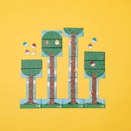 Colorful bird card game with illustrated trees, birds, and egg tokens on a bright yellow background.