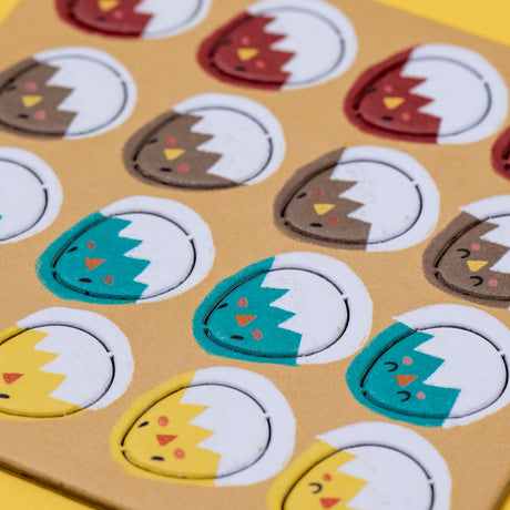 Colorful Londji Piu Piu counting game tokens featuring illustrated hatching chicks in red, brown, teal, and yellow.