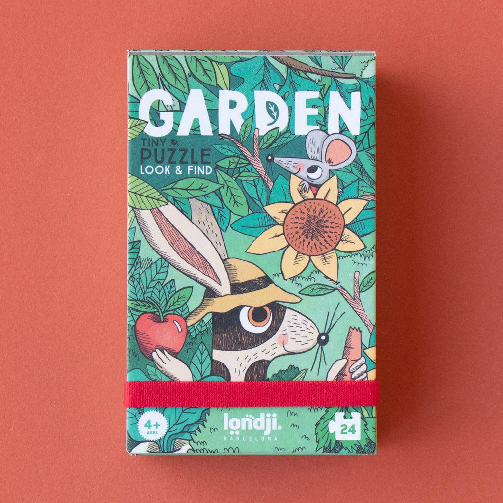 Colorful "Garden" puzzle box features whimsical animals, a sunflower, and vibrant greenery. Includes text "Tiny Puzzle Look & Find." Playful and engaging.