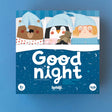 Illustrated game box cover with a bear, penguin, and child in pajamas and blue sleep caps, lying in bed. Text reads "Good night." Playful, cozy tone.
