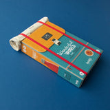 Londji Wonderful World board game box designed like a backpack with a rolled fabric map on a blue background.
