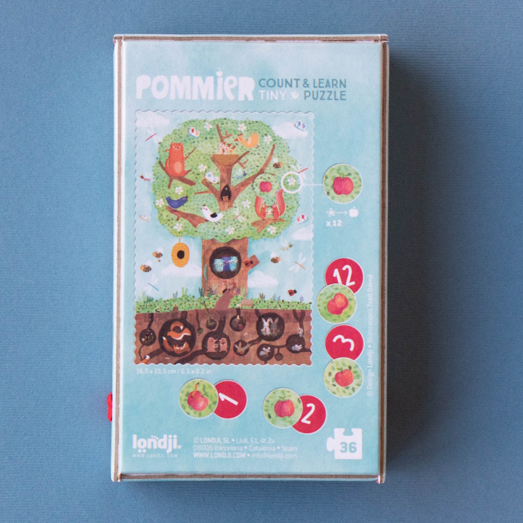 Box cover of a "Pommier Count & Learn" puzzle. Features a whimsical apple tree with animals and numbers. Bright and playful design, with twelve apple illustrations.