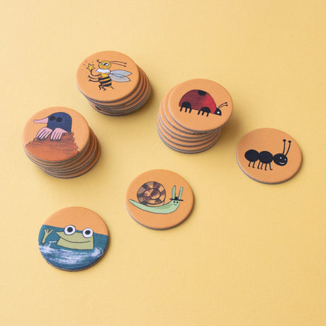 Stacks of Londji Bear's Forest Puzzle round cardboard tokens featuring illustrated forest animals and insects.