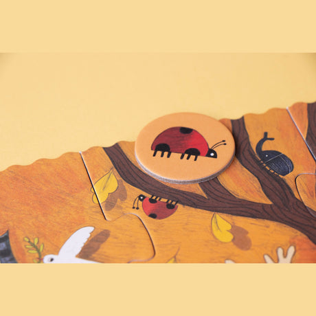 Londji Bears Forest puzzle piece featuring a ladybug disc on an autumn-themed illustration of trees and insects.