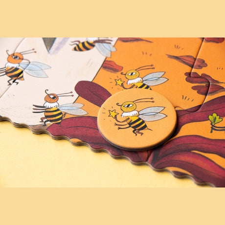 Close-up of a Londji Bears in the Forest puzzle featuring whimsical bumblebee illustrations and a circular game token.
