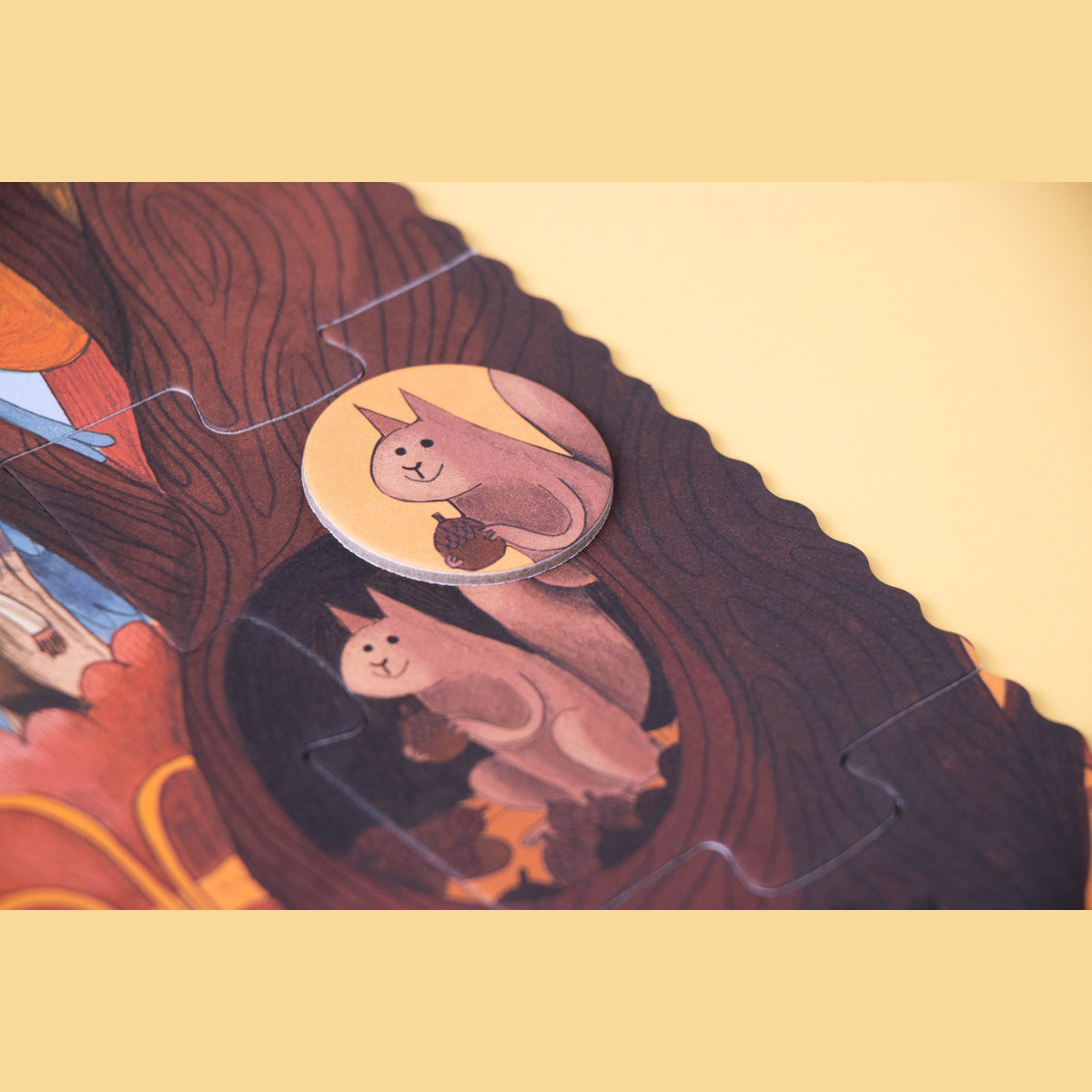 Londji Bears in the Forest puzzle detail showing a squirrel game piece matching an illustration in a hollow tree.
